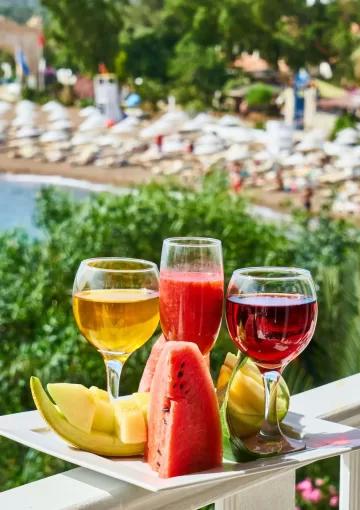 platter of wine and fruit in front of a beach
