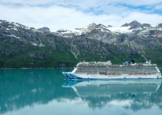 Cruise ship going past mountains - Viking Travel