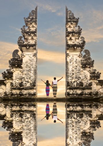 Happy couple standing in the gates of the temple of heaven, holding each other's hand. - Viking Travel