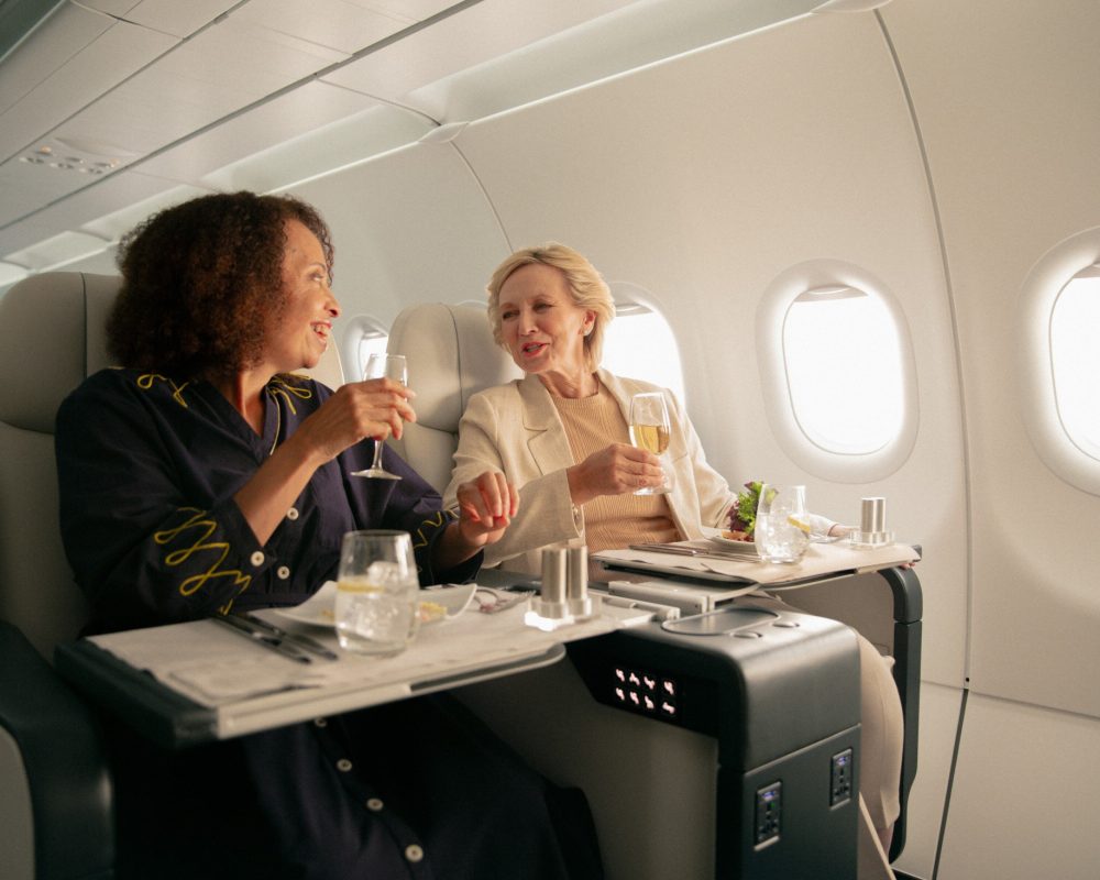 Passengers enjoying drinks on a private jet - Viking Travel