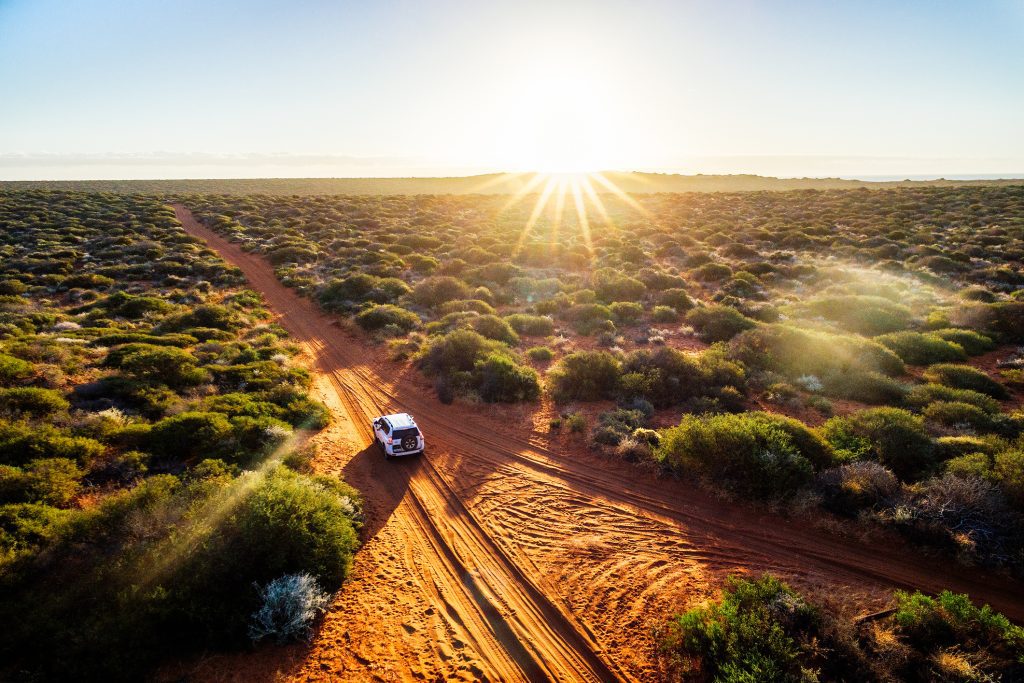 Driving off-road in Western Australia at sunset - Viking Travel