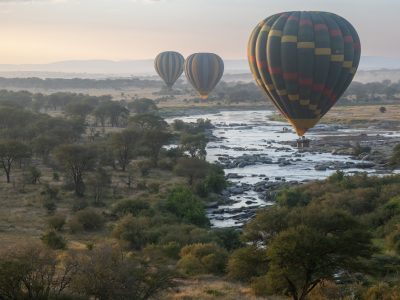 the Mara from above – the Mara River seen from above aboard a hot air balloon with other hot air balloons around, with beautiful morning light at sunrise - Serengeti – Tanzania