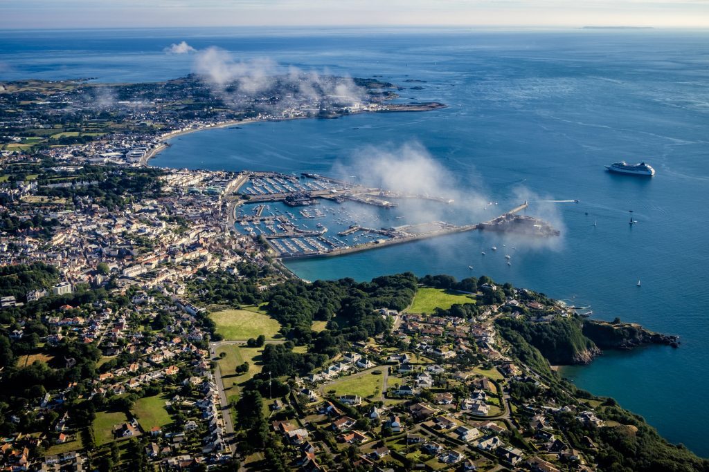 Aerial view of St Peter Port, capital of Guernsey, Channel Islands, Cruise ship at anchor