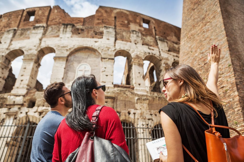 Guide explaining to tourists the Coliseum of Rome