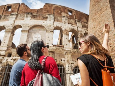 Guide explaining to tourists the Coliseum of Rome
